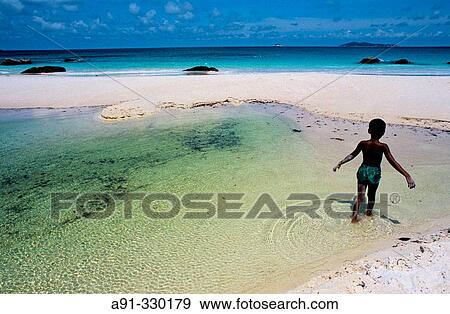 Child in the lagoon. Praslin Island. Seychelles View Large Photo Image Stock Photo - Child in the lagoon. Praslin Island. Seychelles. Fotosearch