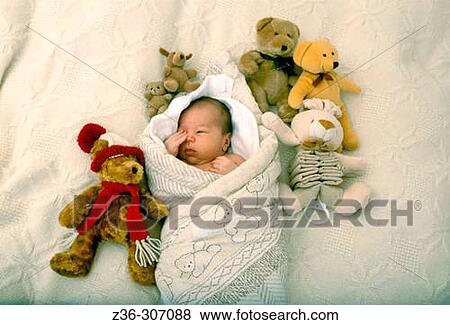 Stock Photo - Child infant boy with bear toys. Fotosearch