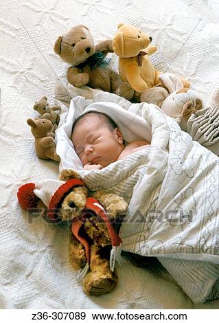 Stock Photo - Child infant boy with bear toys. Fotosearch
