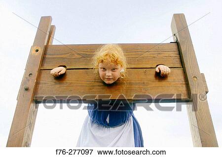 Child locked in 1700's pillory at the annual Pequawket Alliance re-enactment of 1790's life. Jefferson, New Hampshire. USA View Large Photo Image Stock Photo - Child locked in 1700's pillory at the annual Pequawket Alliance re-enactment of 1790's life. Jefferson, New Hampshire. USA. Fotosearch