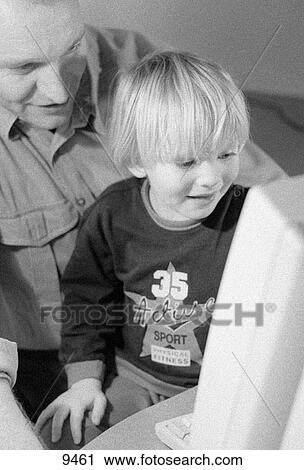 Child on father's knee at computer View Large Photo Image Stock Image - Child on father's knee at computer. Fotosearch
