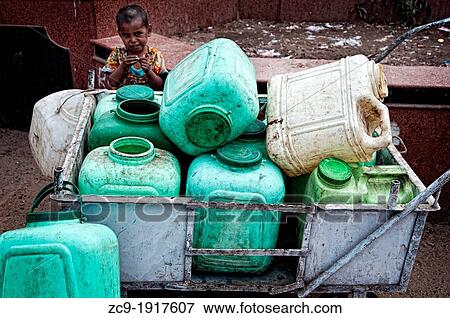 Child playing behind a cart full of petrol cans Mt Abu, Rajasthan, India View Large Photo Image Stock Photo - Child playing behind a cart full of petrol cans Mt Abu, Rajasthan, India. Fotosearch