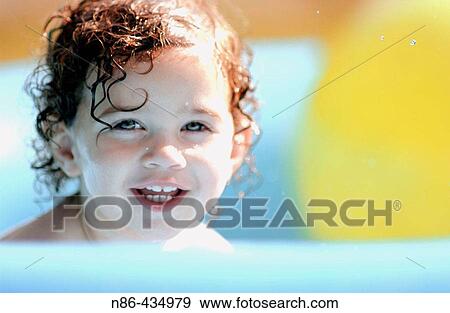 Child playing in pool, summertime View Large Photo Image Stock Photo - Child playing in pool, summertime. Fotosearch