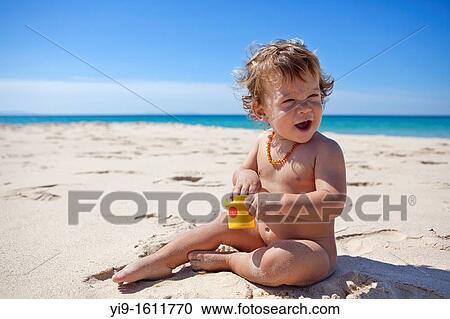 child playing with the sand on the beach View Large Photo Image Stock Image - child playing with the sand on the beach. Fotosearch