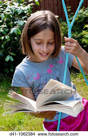 child reading book outdoors 2009 View Large Photo Image Picture - child reading book outdoors 2009. Fotosearch