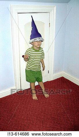 Stock Photograph - Child wearing a wizard hat. Fotosearch