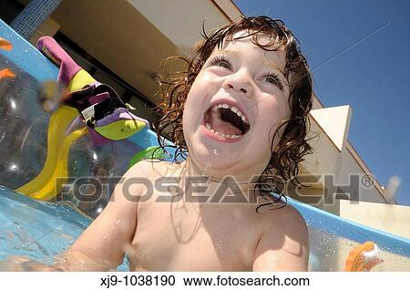 Child who can swim in the pool in the garden. View Large Photo Image Stock Image - Child who can swim in the pool in the garden.. Fotosearch
