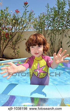 Child who can swim in the pool in the garden. View Large Photo Image Stock Photo - Child who can swim in the pool in the garden.. Fotosearch