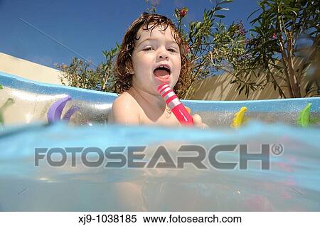 Child who can swim in the pool in the garden. View Large Photo Image Stock Photography - Child who can swim in the pool in the garden.. Fotosearch