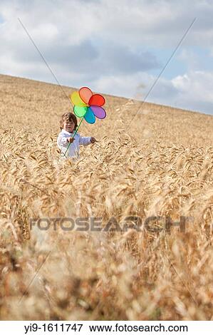 child with a pinwheel in the field View Large Photo Image Stock Photo - child with a pinwheel in the field. Fotosearch