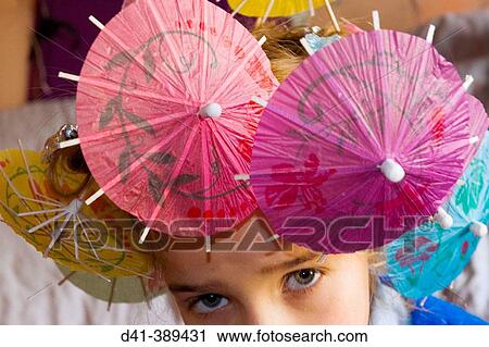 Child with cocktail stick umbrella hairdo View Large Photo Image Stock Image - Child with cocktail stick umbrella hairdo. Fotosearch