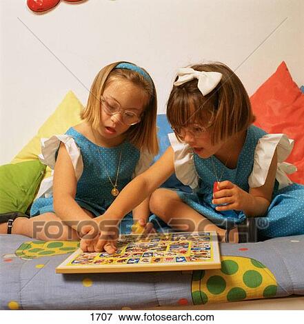 Child with Down syndrome on left View Large Photo Image Stock Photo - Child with Down syndrome on left. Fotosearch