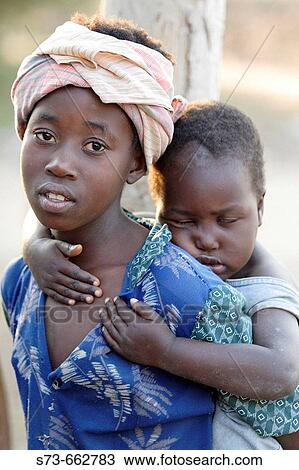 Stock Image - Child with his brother. Mozambique. Fotosearch