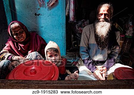 Stock Image - Child with his grandparents Varanasi, Benares, Uttar Pradesh, India. Fotosearch