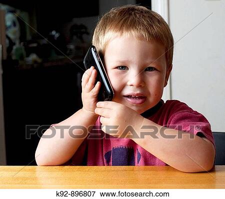 Child with mobile phone View Large Photo Image Stock Photo - Child with mobile phone. Fotosearch