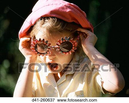 Stock Photo - Child with sunglasses and pink hat, surprised. Fotosearch