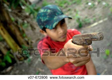 Child with toy gun in one of the Amazone communities, CametB. Brazil. View Large Photo Image Stock Photograph - Child with toy gun in one of the Amazone communities, CametB. Brazil.. Fotosearch