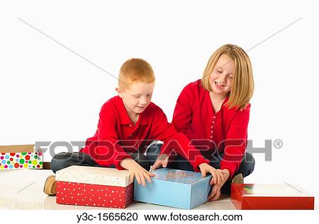 Stock Image - Children almost fighting over Christmas gifts. Fotosearch