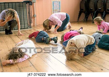 Children and teachers at nursrey school, lying on the floor pretending to be asleep View Large Photo Image Stock Image - Children and teachers at nursrey school, lying on the floor pretending to be asleep. Fotosearch