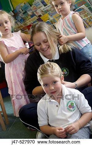 children at nursery, playing at hairdresses, with the teacher View Large Photo Image Stock Image - children at nursery, playing at hairdresses, with the teacher. Fotosearch