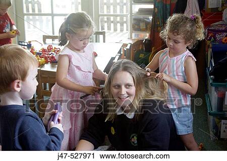 children at nursery, playing at hairdresses, with the teacher View Large Photo Image Stock Image - children at nursery, playing at hairdresses, with the teacher. Fotosearch