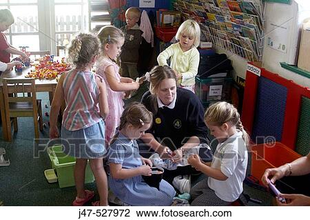 children at nursery, playing at hairdresses, with the teacher View Large Photo Image Stock Image - children at nursery, playing at hairdresses, with the teacher. Fotosearch