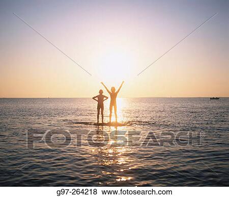 Children at shoal in sunset View Large Photo Image Stock Photo - Children at shoal in sunset. Fotosearch