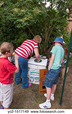 Children buying ice cream at a village fete in Weston, Suffolk, England, Britain, Uk View Large Photo Image Stock Photo - Children buying ice cream at a village fete in Weston, Suffolk, England, Britain, Uk. Fotosearch