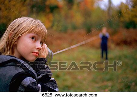 Children communicating over tin can telephone system View Large Photo Image Stock Photography - Children communicating over tin can telephone system. Fotosearch
