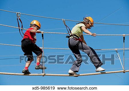 Children crossing rope bridge View Large Photo Image Stock Photo - Children crossing rope bridge. Fotosearch