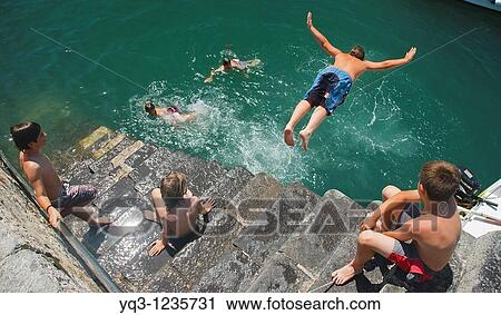 Children diving in, Castro Urdiales, Cantabria, Spain View Large Photo Image Stock Image - Children diving in, Castro Urdiales, Cantabria, Spain. Fotosearch