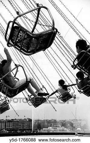 children enjoying carousel ride, Geneva, Switzerland, famous fountain Jet d? Eau, ferry boat and buildings of Geneva in the background View Large Photo Image Stock Photo - children enjoying carousel ride, Geneva, Switzerland, famous fountain Jet d? Eau, ferry boat and buildings of Geneva in the background. Fotosearch