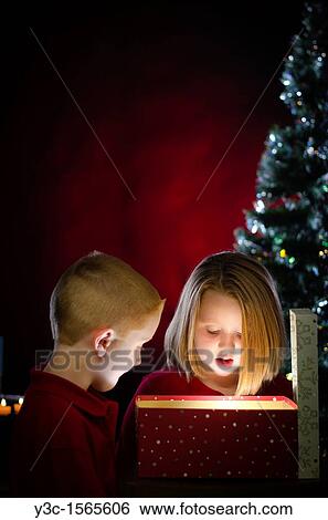 Stock Photograph - Children enyoying Christmas presents. Fotosearch