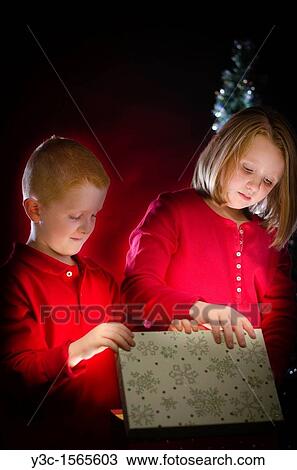 Children getting presents for Christmas View Large Photo Image Stock Image - Children getting presents for Christmas. Fotosearch