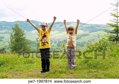 Picture - Children happy with climbing a mountain.. Fotosearch