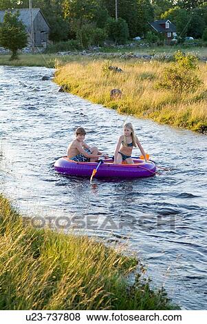Children in a plastic boat. View Large Photo Image Stock Photo - Children in a plastic boat.. Fotosearch