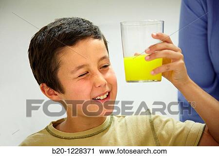 Stock Image - Children in an orange soft drink tasting session tutored by a sensory analysis specialist, AZTI-Tecnalia Marine and Food Research Center, Derio, Bizkaia, Euskadi, Spain. Fotosearch