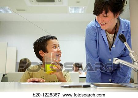 Stock Photo - Children in an orange soft drink tasting session tutored by a sensory analysis specialist, AZTI-Tecnalia Marine and Food Research Center, Derio, Bizkaia, Euskadi, Spain. Fotosearch