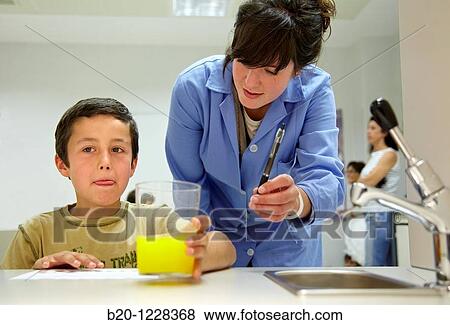Stock Photo - Children in an orange soft drink tasting session tutored by a sensory analysis specialist, AZTI-Tecnalia Marine and Food Research Center, Derio, Bizkaia, Euskadi, Spain. Fotosearch