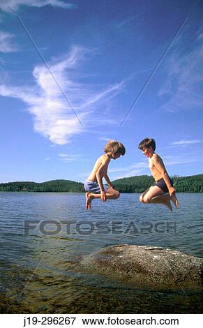 Children jumping on a stone in water View Large Photo Image Stock Photo - Children jumping on a stone in water. Fotosearch