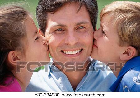 Children kiss their father. View Large Photo Image Stock Image - Children kiss their father.. Fotosearch