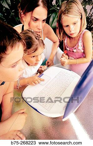 Children learning with a laptop View Large Photo Image Stock Image - Children learning with a laptop. Fotosearch