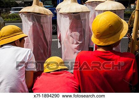 Stock Image - children looking the Sanno Matsuri parade, near the Ichigaya station The parade begins and ends at HieJinja shrine, Nagata-cho Tokyo city, Japan, Asia. Fotosearch