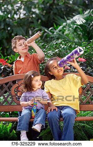 Children looking through kaleidoscope View Large Photo Image Stock Photo - Children looking through kaleidoscope. Fotosearch
