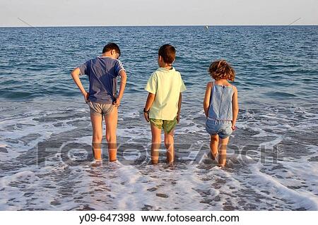 Stock Photo - Children on the beach.. Fotosearch