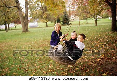Children on tire swing. USA. View Large Photo Image Stock Photograph - Children on tire swing. USA.. Fotosearch