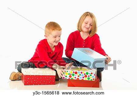 Children opening Christmas presents View Large Photo Image Stock Photo - Children opening Christmas presents. Fotosearch