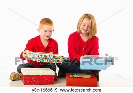 Children opening Christmas presents View Large Photo Image Stock Photo - Children opening Christmas presents. Fotosearch
