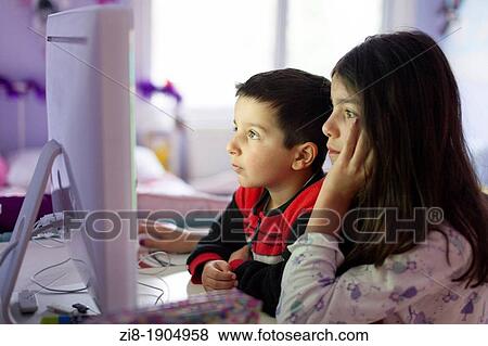 Stock Photo - Children playing computer games together. Fotosearch