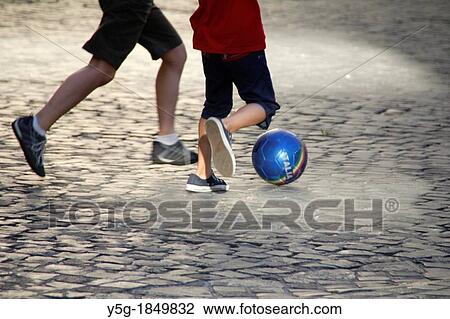 children playing football in street in rome italy View Large Photo Image Stock Image - children playing football in street in rome italy. Fotosearch